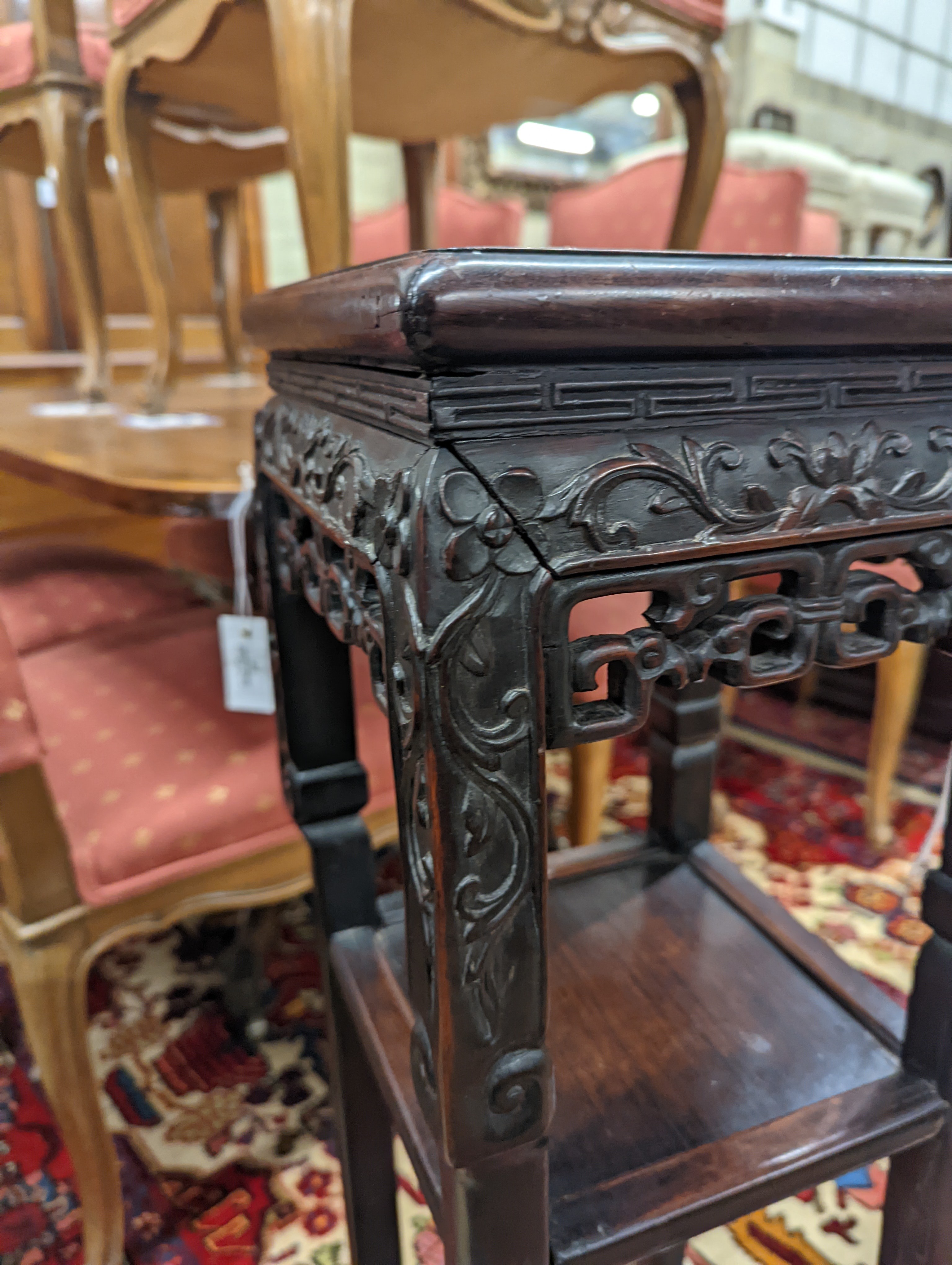 A Chinese carved hardwood three tier jardiniere stand, marble inset, width 22cm, depth 22cm, height 82cm